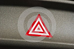 Car emergency attention light button in red triangle