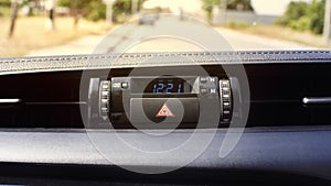 Car emergency light button and clock digital display.