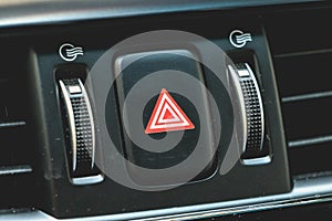 Car emergency light button on a modern dashboard