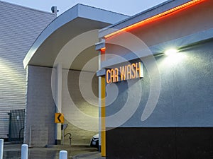 Car emerging from car wash station in evening light