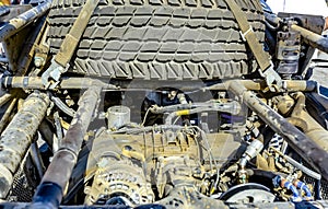 Car Engine in the back of an offroad vehicle dirty from the desert with a spare tire