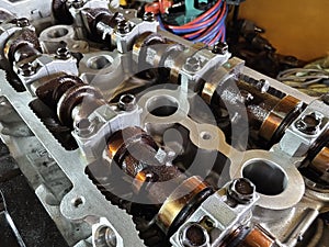 A car engine is being worked on inside a garage workshop