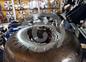 A car engine is being worked on inside a garage workshop