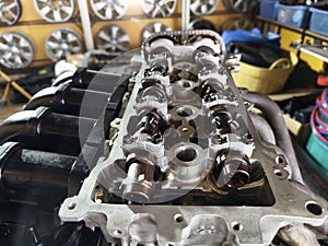 A car engine is being worked on inside a garage workshop