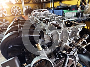 A car engine is being worked on inside a garage workshop