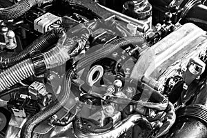 Car engine. Car engine part. Close-up image of an internal combustion engine. Engine detailing in a new car. Car detailing. Black