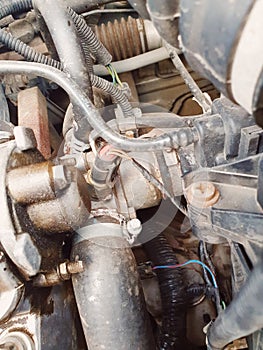 car engine parts close-up, thermostat and nozzles