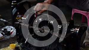 Car engine repair technician test rotating crankshaft