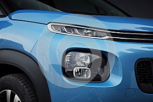 Car exterior: LED Headlights and Fog Lights of a blue SUV