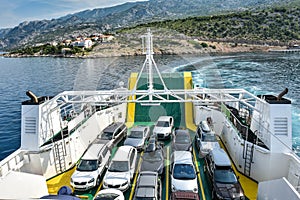 Car Ferry Boat with rows of cars is leaving the port.