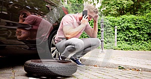 Car With Flat Tire. Man Calling