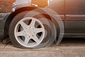 car with flat tire parking outdoor in hot weather damaged old broken vehicle need to service