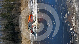 The car is fording a water obstacle. Ice Capade Champion Bold Vehicle Northern Escapade. Vertical 9x16 Aerial Drone shot