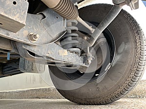 Car Front Axle Shocker and Tyre Close up. photo