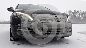 Car front covered with frozen snow