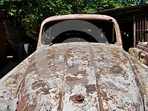 Car front of old rusty abandoned vintage car.