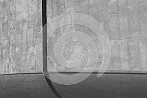 Car in front of plaster wall and reflection. black an white.