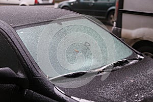 Car frozen windscreen and windscreen wipers after freezing rain