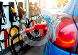 Car fueling at gas station. Refuel fill up with petrol gasoline. Petrol pump filling fuel nozzle in fuel tank of car at gas