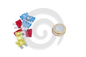 Car fuse. brazilian currency and pile of colorful electrical automotive fuses or circuit breakers