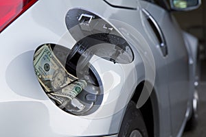 car, gas cap and money