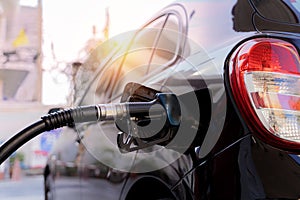 Car gas nozzle automatic refueling. Refueling with premium gasoline at a gas station Close up gas pump nozzle