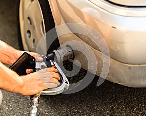 Car at gas station being filled with fuel