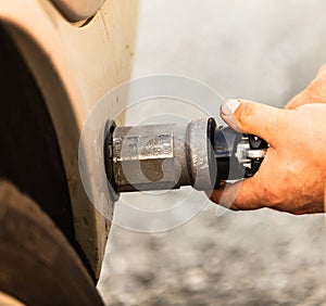 Car at gas station being filled with fuel