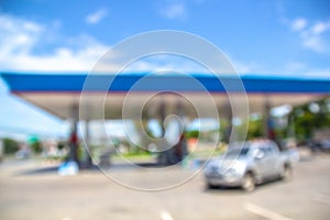 .Car gas station is filling with oil. Blur image