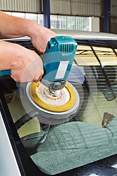 Car Glass polishing with power buffer machine photo