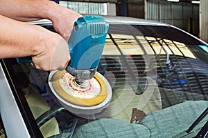 Car Glass polishing with power buffer machine photo