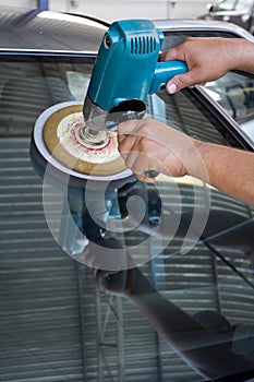 Car Glass polishing with power buffer machine photo