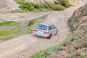 car goes down the mountain dirt road