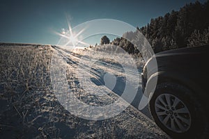 The car goes uphill on a winter road