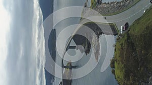 Car is going on Atlantic Ocean Road in Norway. Aerial View. Vertical Video