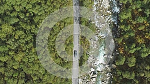 Car is Going on Country Road in Ravine in Norway in Summer Day. Aerial Vertical Top-Down View. Vertical Video