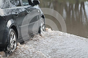 Car Going Through Flood photo