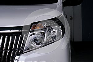 Car headlight on white car