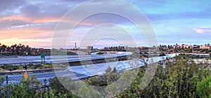 Car headlight trails at sunset traveling across a highway in New