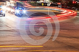 Car Headlights And Brakelights Make Motion Blurred Streaks At Intersection