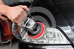 Car headlights cleaning with power buffer machine photo