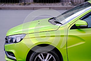 Car headlights close-up. Close-up of the front of the car. Abstract street background. Street style