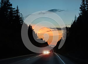 Car headlights glare in evening traffic