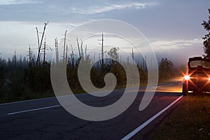 car with headlights on the side of the road