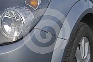 Car headlights and tyre in a close up