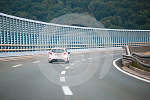 Car on the highway with noise barrier