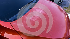 Car hood scratched with deep damage to the paint. Dent car scratch. Crashed car in accident.