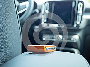 Car ignition key on the armrest in the interior of a modern car.