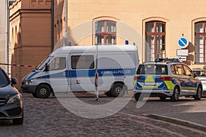 Car with the inscription Criminal police and police at the scene