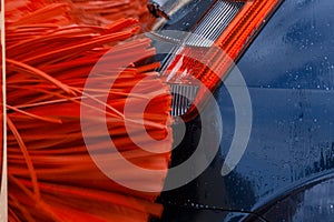 A car inside a car washing machine while it is working